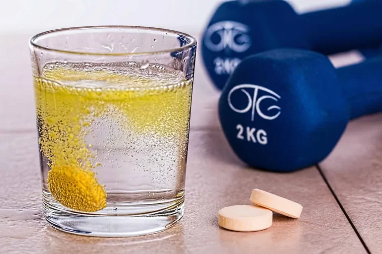 Různé lahve s izotonickými a proteinovými nápoji, připravené k podpoře sportovního výkonu a regenerace po tréninku.