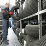 Engineers meticulously test advanced sensors integrated into a vehicle wheel, crucial for modern Tyre and Vehicle Safety Technology Development.